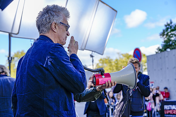 <span style='display:inline-block; background-color:#DF071E; width: 100%;padding:5px;'>Tournage <em>Sortie d'usine</em> de Wim Wenders</span>